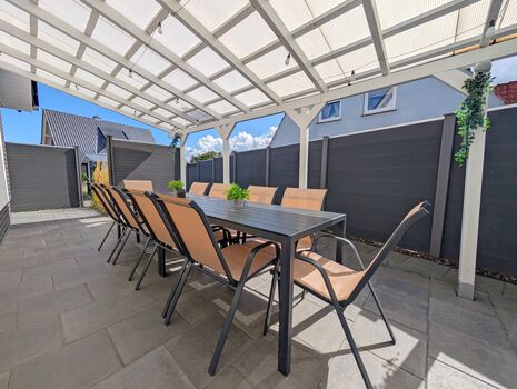 Überdachte Terrasse mit großem Esstisch und Gartenstühle für 10P Überdachte Terrasse mit großem Esstisch und Gartenstühle für 10P